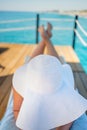 Beautiful young woman reading book while relaxing on sun lounger near swimming pool Royalty Free Stock Photo