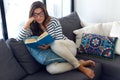 Beautiful young woman reading a book on the sofa. Royalty Free Stock Photo