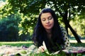 Beautiful young woman reading outdoor Royalty Free Stock Photo