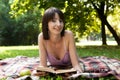 Beautiful young woman reading outdoor Royalty Free Stock Photo