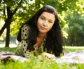 Beautiful young woman reading outdoor Royalty Free Stock Photo