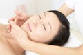 Beautiful young woman receiving facial massage Royalty Free Stock Photo