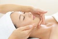 Beautiful young woman receiving facial massage Royalty Free Stock Photo