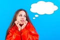 Beautiful young woman in a red dress jacket with a thought bubble emanating from her head Royalty Free Stock Photo