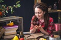 Beautiful young woman in a red dress sitting at the autumn table writing in a notebook. Concept of autumn romantic mood Royalty Free Stock Photo