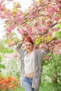 Beautiful young woman with red hair having fun standing in cherry blossom tree Royalty Free Stock Photo