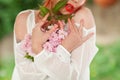 Beautiful young woman with red hair having fun standing in the garden with cherry blossom branch Royalty Free Stock Photo