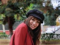 Beautiful young woman with red jacket and black cap Royalty Free Stock Photo