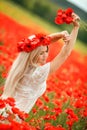 Beautiful young woman in red light poppy field Royalty Free Stock Photo