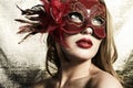 Beautiful young woman in a red mysterious mask Royalty Free Stock Photo