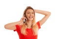 Beautiful young woman in red t shirt speak on a smart phone isolated over white background - phone chat Royalty Free Stock Photo