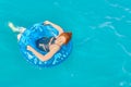 Beautiful young woman relax on inflatable ring in sea water