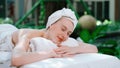 Beautiful young woman relaxes on a spa bed surrounded by nature. Tranquility Royalty Free Stock Photo