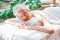Beautiful young woman relaxes on a spa bed surrounded by nature. Tranquility Royalty Free Stock Photo
