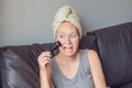 Beautiful young woman relaxing with face mask at home. Happy joy Royalty Free Stock Photo