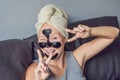 Beautiful young woman relaxing with face mask at home. Happy joy Royalty Free Stock Photo