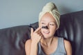 Beautiful young woman relaxing with face mask at home. Happy joy Royalty Free Stock Photo