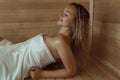 Beautiful young woman relaxing in Finnish sauna Royalty Free Stock Photo