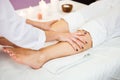 Beautiful young woman relaxing with hand massage at beauty spa.