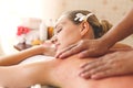 Beautiful young woman relaxing with hand massage at beauty spa. Body salt massage. Closed up of young beautiful woman getting spa Royalty Free Stock Photo