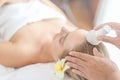Beautiful young woman relaxing with hand massage at beauty spa. Face massage. Closed up of young beautiful woman getting spa Royalty Free Stock Photo
