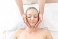 Beautiful young woman relaxing with hand massage at beauty spa. Face massage. Closed up of young beautiful woman getting spa Royalty Free Stock Photo