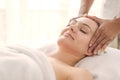 Beautiful young woman relaxing with hand massage at beauty spa. Face massage. Closed up of young beautiful woman getting spa Royalty Free Stock Photo