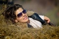 Beautiful young woman relaxing on hay stack Royalty Free Stock Photo