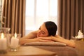 Time to unwind. A beautiful young woman relaxing on a massage table before her massage.