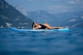 Beautiful young woman relaxing on paddle board in the summer lake or sea water. Summer resort. Sexy sensual fit woman Royalty Free Stock Photo