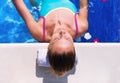 Beautiful young woman is relaxing in pool outdoor. Beauty and body care, spa in luxury hotel resort, tropical vacation travel. Royalty Free Stock Photo