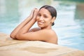 Come join me by the pool. a beautiful young woman relaxing in a swimming pool on a sunny day. Royalty Free Stock Photo