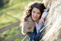 Beautiful young woman relaxing under a hay stack Royalty Free Stock Photo