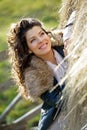 Beautiful young woman relaxing under a hay stack Royalty Free Stock Photo