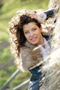 Beautiful young woman relaxing under a hay stack Royalty Free Stock Photo