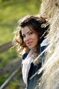 Beautiful young woman relaxing under a hay stack Royalty Free Stock Photo