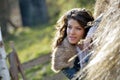 Beautiful young woman relaxing under hay stack Royalty Free Stock Photo