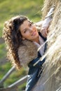 Beautiful young woman relaxing under hay stack in autumn Royalty Free Stock Photo