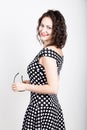 Beautiful young woman removes sun glasses, wears a dress with polka dots. expressing different emotions Royalty Free Stock Photo