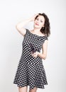 Beautiful young woman removes sun glasses, wears a dress with polka dots. expressing different emotions Royalty Free Stock Photo