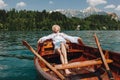 beautiful young woman resting in boat at tranquil mountain lake Royalty Free Stock Photo