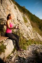 Beautiful young woman resting after climbing the mountain on a h Royalty Free Stock Photo