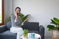 Beautiful woman resting on comfortable sofa and having cell phone conversation. Royalty Free Stock Photo