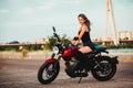 Beautiful young woman riding on a motorcycle Royalty Free Stock Photo