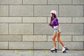 Beautiful young woman on roller skates and a pink helmet Royalty Free Stock Photo