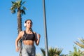 Beautiful young Woman running jogging in a park outdoors listeni