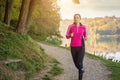 Beautiful young woman running at the lake Royalty Free Stock Photo