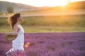 Beautiful young woman running through a lavender field Royalty Free Stock Photo