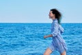 Beautiful young woman running on sea beach Royalty Free Stock Photo