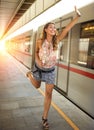 Beautiful young woman running after a train. Royalty Free Stock Photo